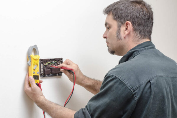 Man repairing a bathroom sink faucet with tools
