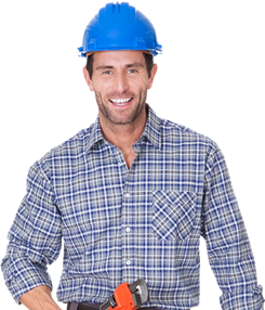 Smiling male technician wearing a blue hard hat and checkered shirt, standing confidently.