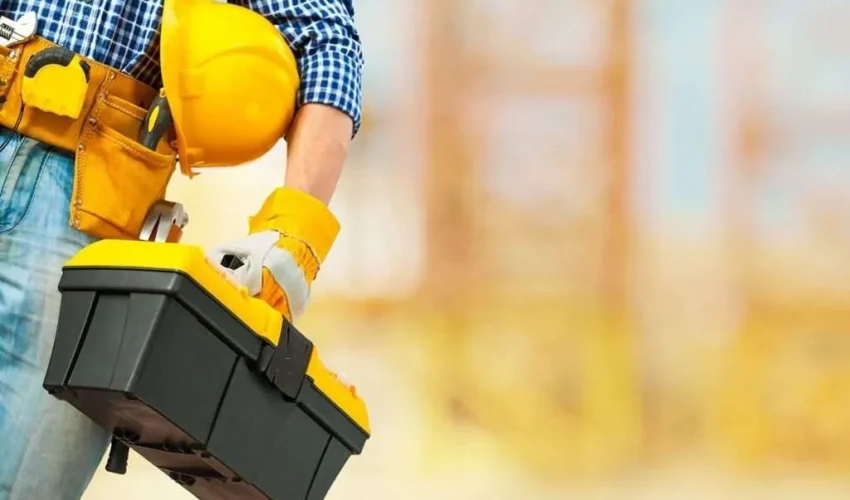 Handyman Dubai professional holding a toolbox and safety helmet for home repair and maintenance work