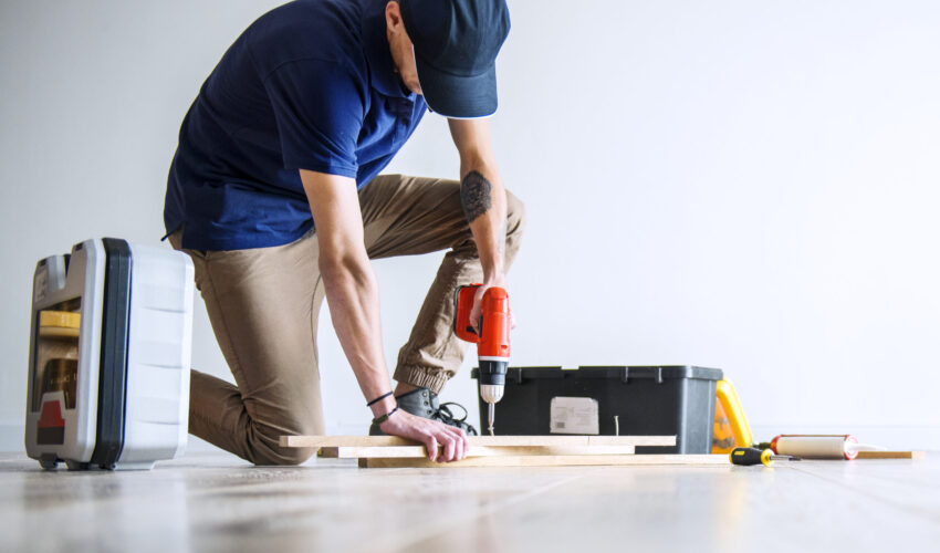 Handyman in Dubai fixing wooden fittings using professional tools during home maintenance work