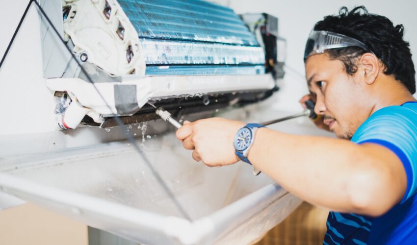 Technician performing AC repair in Dubai checking cooling system components