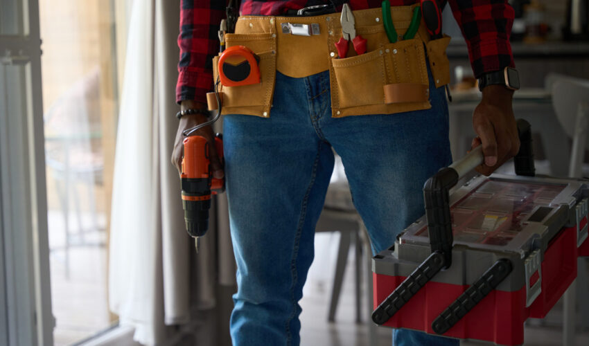 Handyman UAE technician carrying tools and drill for home repair work