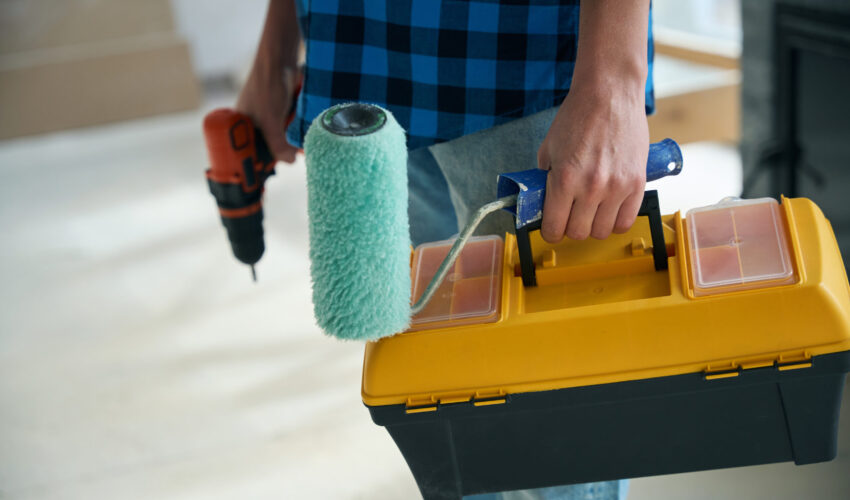 Home Maintenance tools including paint roller and drill for property repair