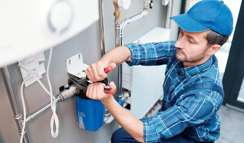 Plumbing company in Dubai technician fixing water filter and pipes