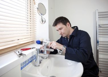 project01 Man repairing a bathroom sink faucet with tools