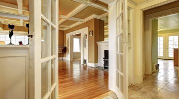 Elegant hallway with wooden floors and decorative ceiling design