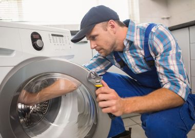project09 Technician repairing a front-loading washing machine